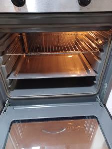 an oven with two racks inside of it at Casa Ferrer Barcelona in Hospitalet de Llobregat