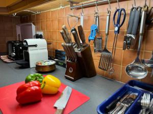 a kitchen counter with a red cutting board and utensils at Cosy home in a beautiful valley in Tipperary