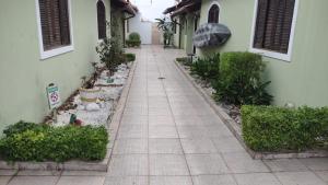 a tiled walkway in front of a building at Casa Praia Indaia in Caraguatatuba
