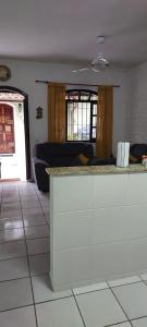a living room with a counter and a couch at Casa Praia Indaia in Caraguatatuba