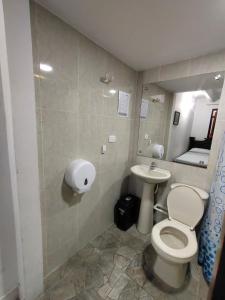 a bathroom with a toilet and a sink at HOGAR DE PASO GUARACAO in Bucaramanga