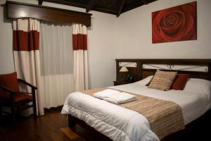 Postel nebo postele na pokoji v ubytování Chuquiragua Lodge & Spa