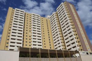 two tall buildings with balconies in front of them at Hot Beach Suites Olimpia Resort in Olímpia