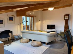 a living room with a white tub in a room at Attic in the Alps in Luzein