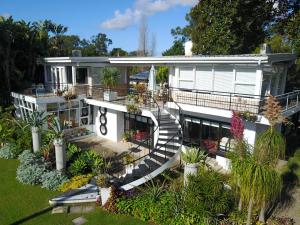 a large white house with stairs and plants at Belairberry in Berry