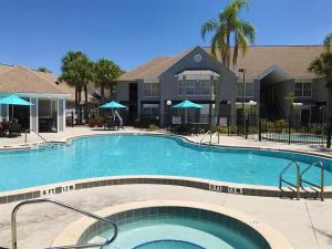 a large swimming pool in front of a building at 2 room DisneyResortVillas by AmericanVacationLiving in Orlando