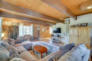 a living room with a couch and a table at Quaint Big Bear Home with Hot Tub 4 Mi to Skiing! in Big Bear City