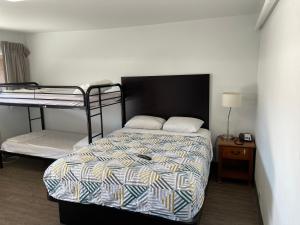 a bedroom with two bunk beds and a night stand at Banfield Studios in Portland