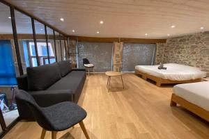 a living room with a couch and a bed at Le Rivet charmant 12 personnes Terreaux in Lyon
