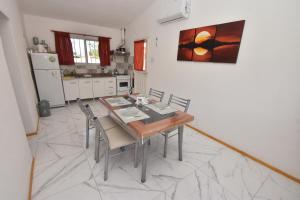 a kitchen with a dining room table and chairs at Kaiken Maison in Villa Santa Cruz del Lago +13 photos