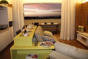 a living room with a couch and a table at Hot Beach Suites Olimpia Resort in Olímpia