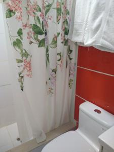 a bathroom with a toilet and a shower curtain at LUGAR DE DESCANSO in Ica