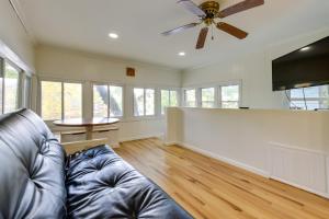 a living room with a couch and a ceiling fan at Horseshoe Lake Vacation Rental with Deck and Kayaks! in Batavia