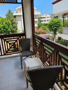 a balcony with chairs and tables on a building at Agon Boutique Hotel in Kemer