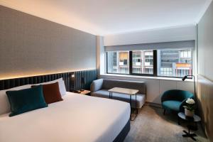 a hotel room with a bed and a window at Novotel Sydney City Centre in Sydney +177 photos