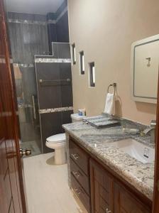 a bathroom with a shower and a sink and a toilet at Villanueva Suite’s in Chacala