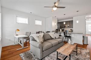 a living room with a couch and a kitchen at Charming Duplex Retreat in Old Town Manchester, VA in Richmond