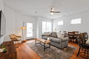 a living room with a couch and a table at Charming Duplex Retreat in Old Town Manchester, VA in Richmond