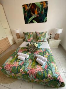 a bedroom with a bed with a colorful comforter at L’Exotique in Menton