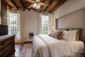 a bedroom with a bed and a ceiling fan at 3BR Garden Home with Rooftop & Garage in Centro San Miguel de Allende in San Miguel de Allende