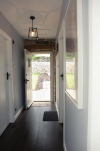 a hallway with a door leading to a yard at The Old Cooling House in Summer Bridge