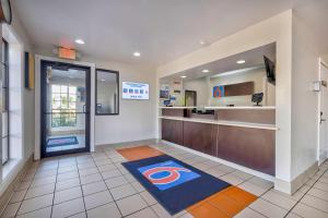 a hotel lobby with a chicago bears rug on the floor at Motel 6-Bryan, TX - College Station in Bryan