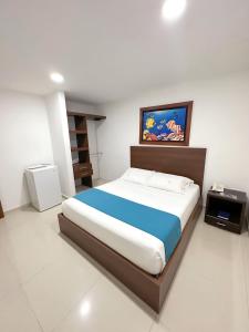 a bedroom with a large bed and a television at Hotel AguaMarina Rodadero Santa Marta in Gaira