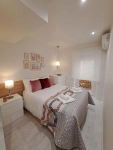 a bedroom with a large bed with red pillows at CANTINHO DAS FIGUEIRAS in Nazaré