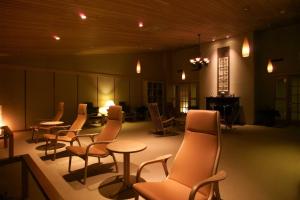 a group of chairs and tables in a room at Shikotsuko Daiichi Hotel Suizantei in Chitose