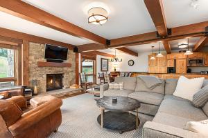 a living room with a couch and a fireplace at Enclave 108, Snowmass Ski-In Ski-Out Condo with Shared Pool, Hot Tub & Gym in Snowmass Village