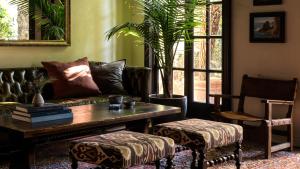 a living room with a couch and a table at La Playa Hotel in Carmel