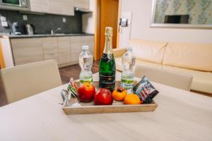 a tray of fruit and bottles on a table at Spirit Harrachov Superior Wellness Apartment - FREE Wellness, Wifi, Parking in Harrachov +37 photos