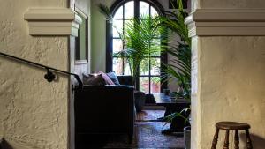 a hallway with plants and a chair and a window at La Playa Hotel in Carmel