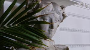 a statue of a woman with a plant in her mouth at La Playa Hotel in Carmel