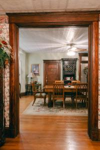 a dining room with a table and chairs at The Wolf Manor in Ellinwood