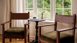 two chairs and a table in front of a window at La Playa Hotel in Carmel