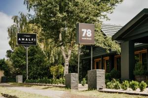 a couple of signs in front of a building at The Amalfi Minimalist Room 506 in Hepburn Springs