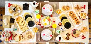 a table with many plates of food on it at Riad Diamond Of Marrakech in Marrakech