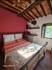- une chambre avec un lit dans une pièce aux murs rouges dans l'établissement La Rocca Sovrana - Casa Vacanze, à Aramo