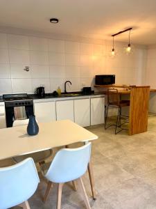 a kitchen with a table and a table and chairs at La Isabel in Esquel