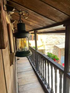 una lanterna appesa sul lato del balcone di 2 bedrooms house with wifi at Tineo a Tineo