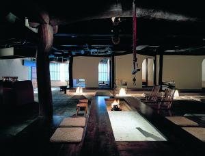 a room with chairs and a fire in the middle at Shikotsuko Daiichi Hotel Suizantei in Chitose