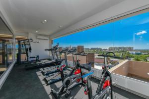 a gym with cardio machines and a large window at Aracari 1 in Palm-Eagle Beach