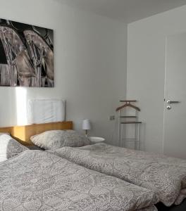 a bedroom with two beds and a painting on the wall at Viva la Wildbad in Bad Wildbad