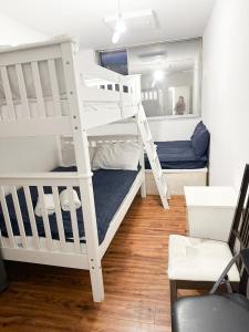 a bedroom with two bunk beds and a chair at 264 rooms in London