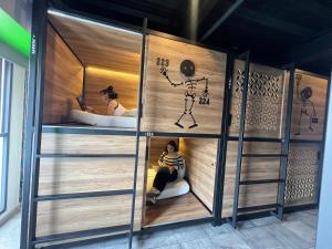 a woman sitting in a sauna with a person in a tub at Barrio Downtown Mexico City Hostel in Mexico City
