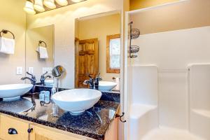 a bathroom with two sinks and a mirror at Horizon Hideaway in Mashburn Mill +39 photos