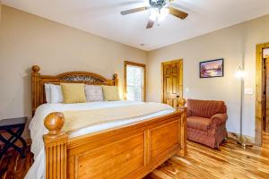 a bedroom with a wooden bed and a chair at Horizon Hideaway in Mashburn Mill