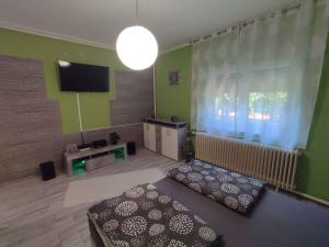 a living room with a couch and a flat screen tv at Holiday home in Siofok - Balaton 45811 in Siófok