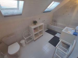 a bathroom with a toilet and a sink and a tub at Holiday home in Balatonboglar 45807 in Balatonboglár +27 photos